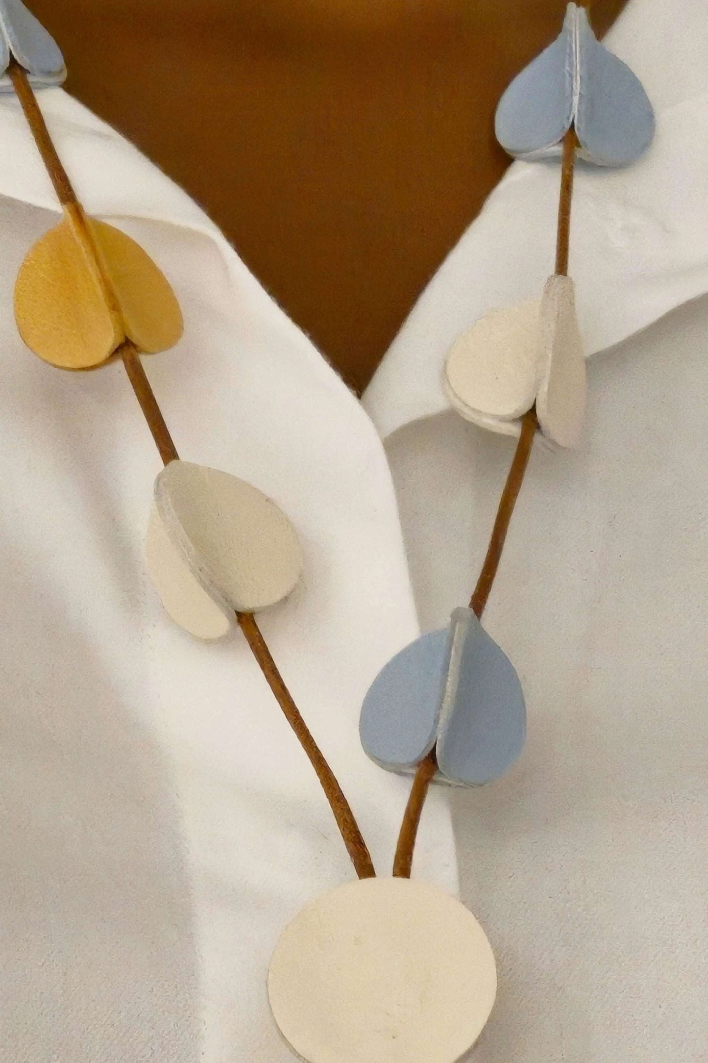 Collana 3D Clear Light handmade light leather necklace with ivory, ochre, and sky blue accents