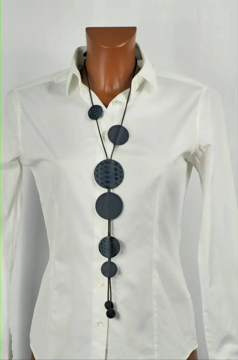 Blu Snake handmade blue python leather necklace with waxed cord on white shirt mannequin