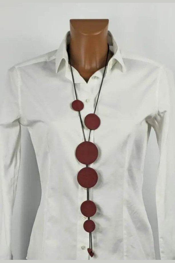 Handmade Buble Burgundy necklace with burgundy leather and waxed cord on white shirt mannequin