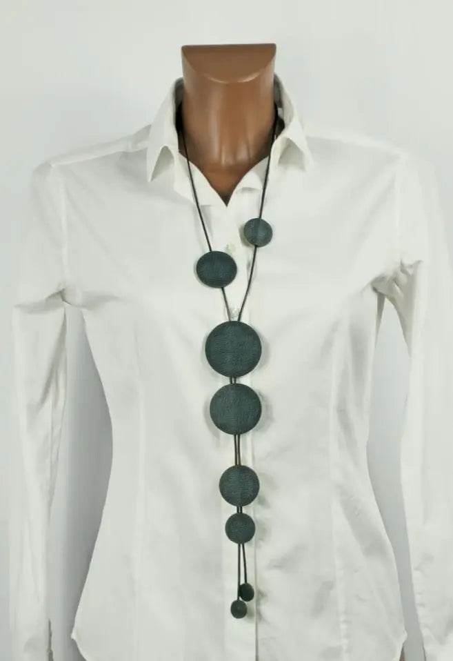 Buble petrolium handmade green leather necklace with waxed cord on white shirt mannequin