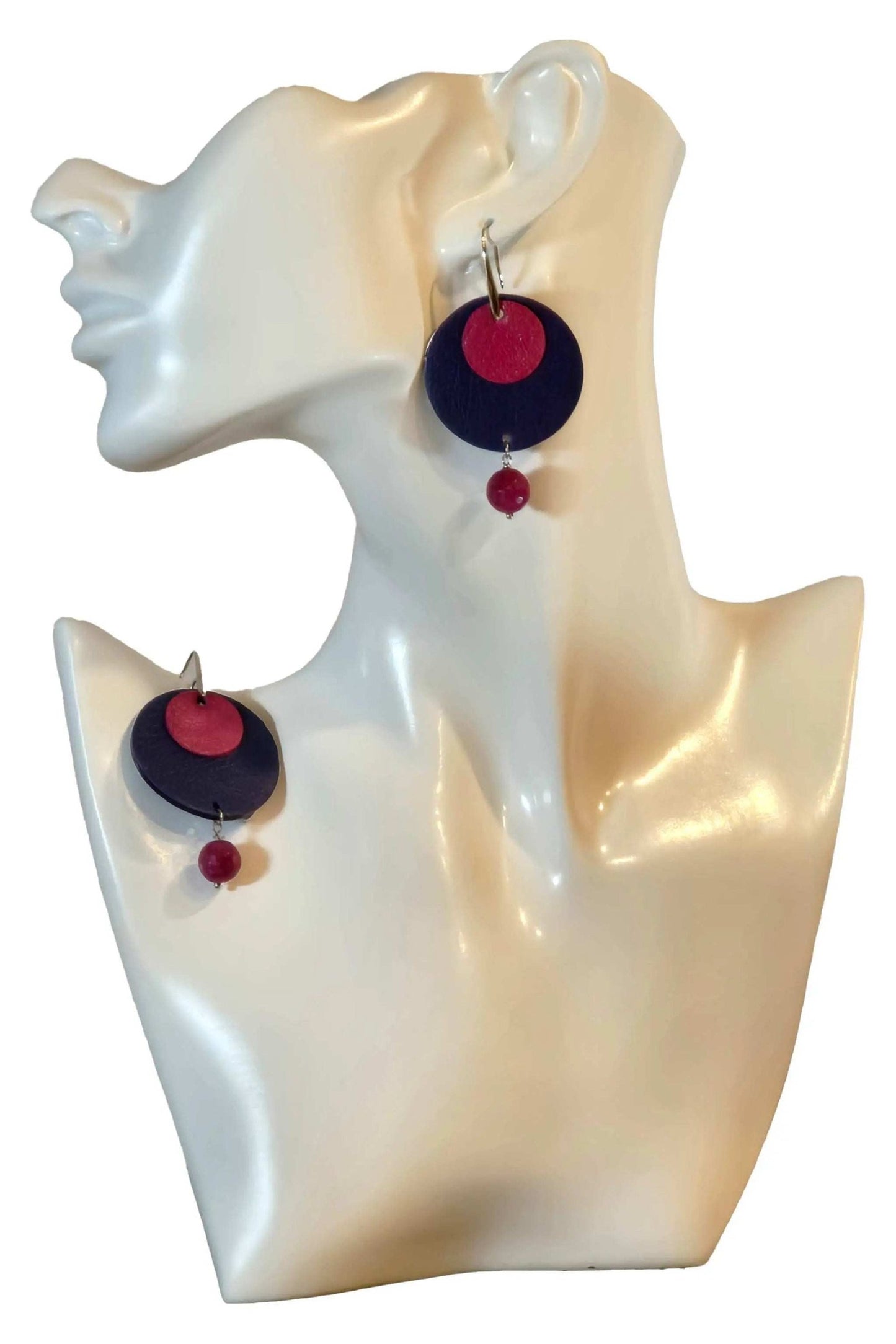 Handmade Orecchini Round Blue leather earrings with raspberry accents on display bust