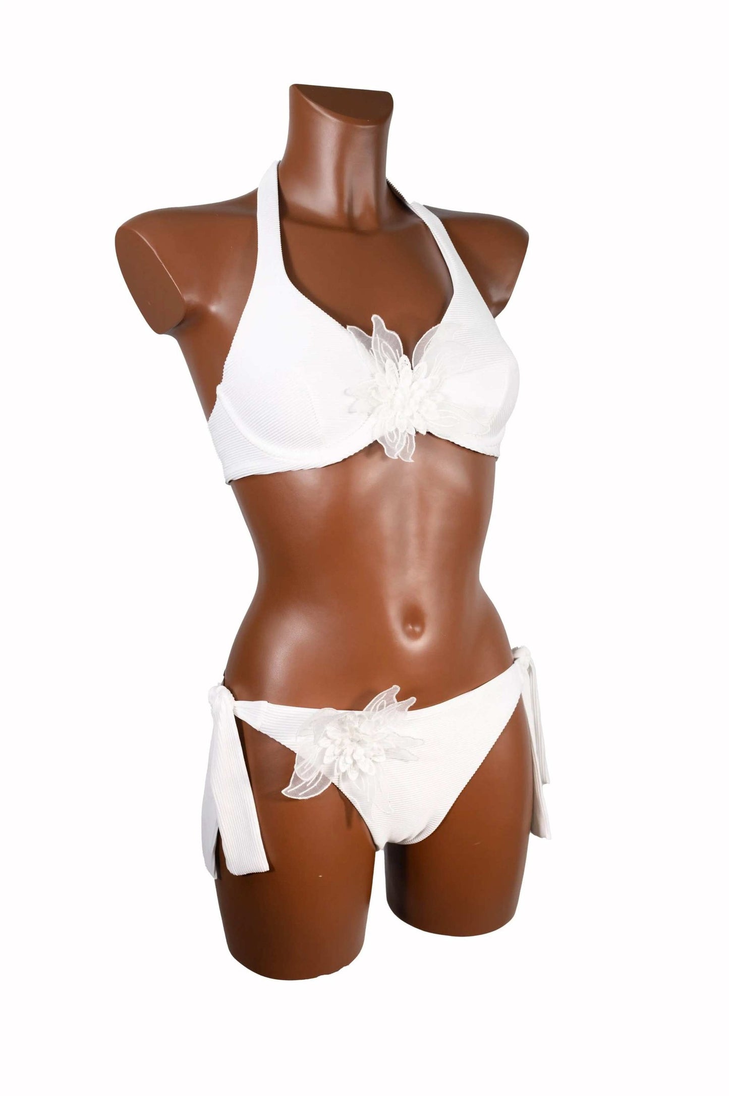 White bikini ferretto with floral appliques and adjustable side ties on mannequin